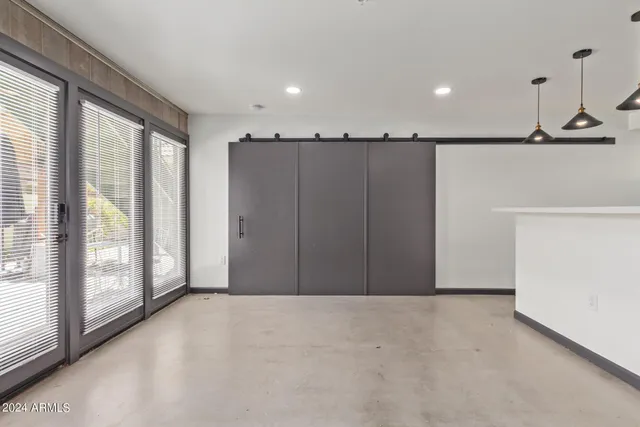 a view of a livingroom with wooden floor and windows