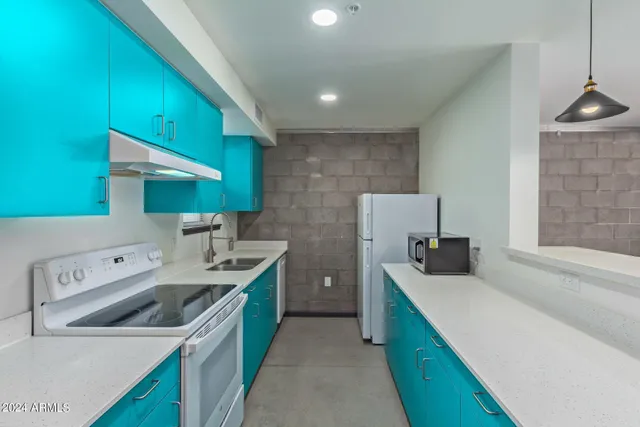 a kitchen that has a sink and a stove