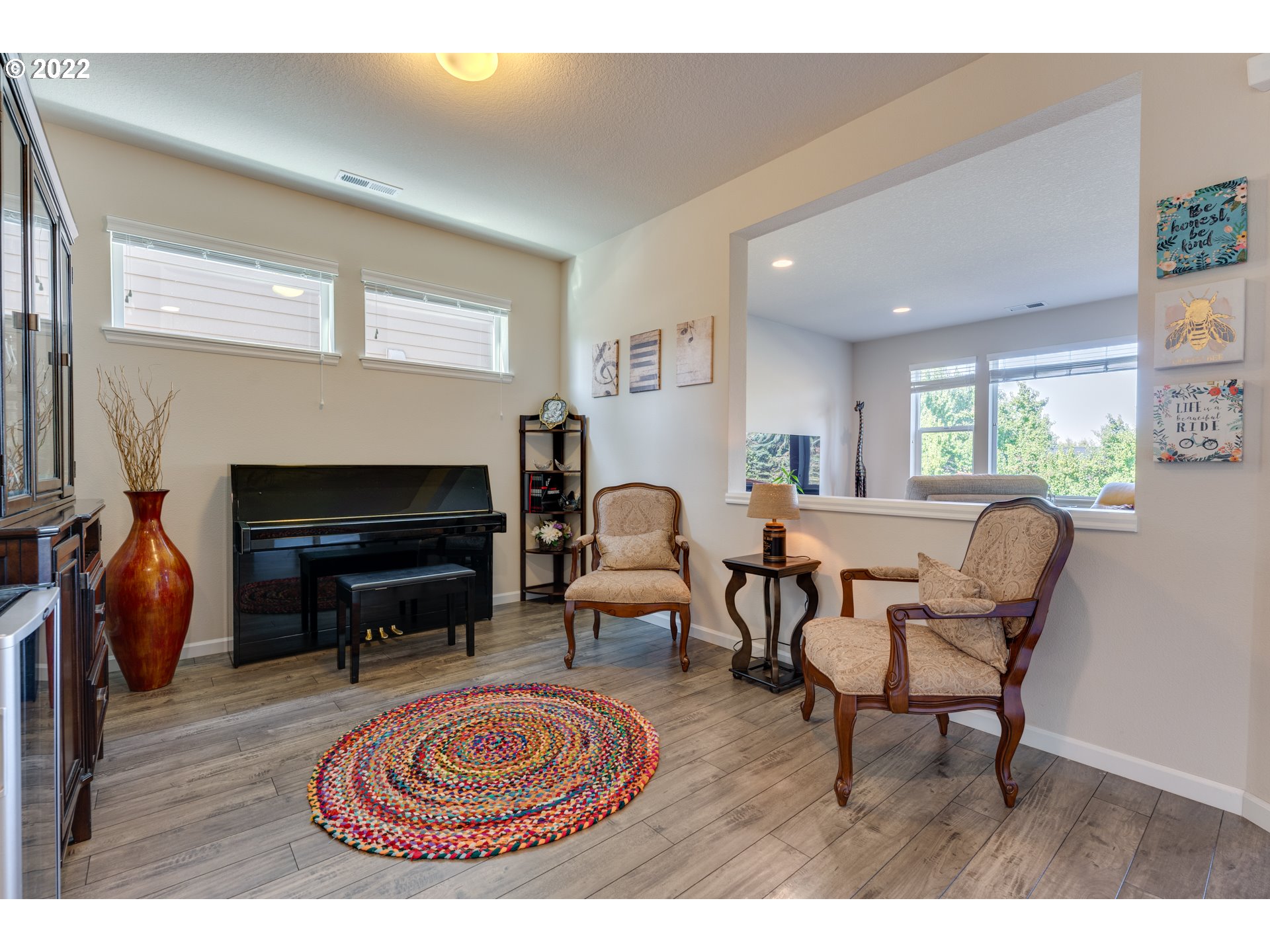 17575 Southeast Pinnacles Street Damascus, OR 97089 - Photo 5 of 32 a living room with furniture a fireplace and a flat screen tv