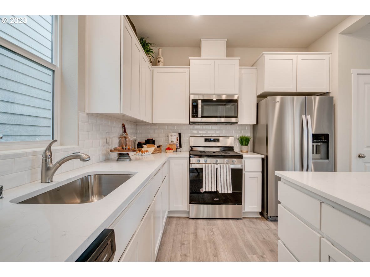2651 26th Loop Springfield, OR 97477 - Photo 14 of 15 a kitchen with stainless steel appliances a refrigerator sink and microwave