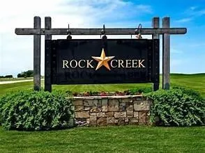 a view of a sign board with a park