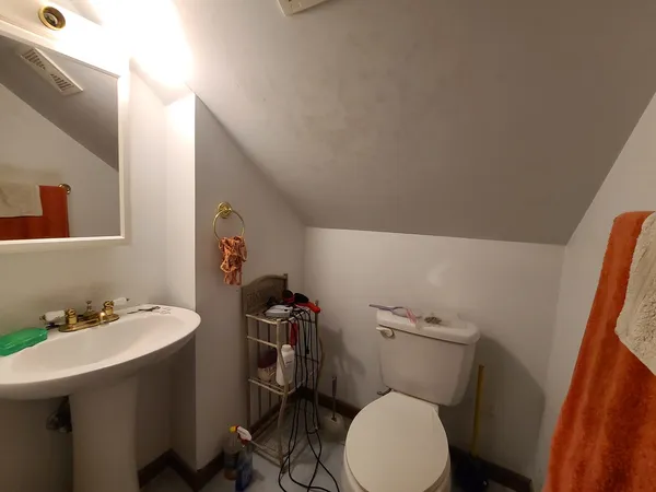 a bathroom with a sink a toilet and a mirror