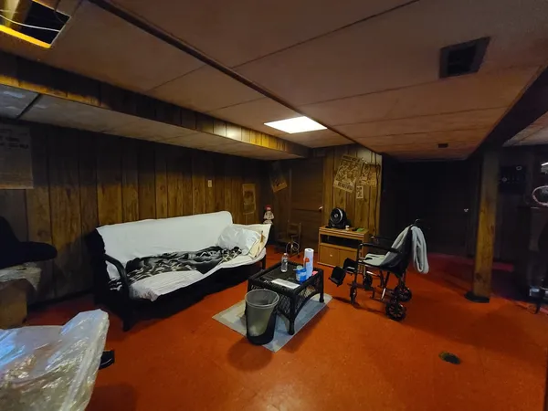 a living room with furniture gym equipment and view of living room