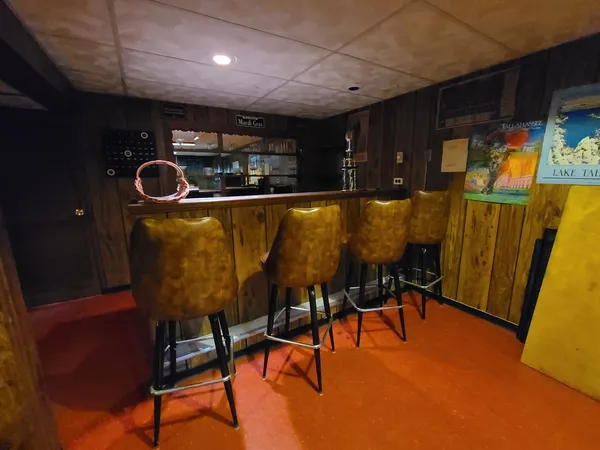 a dining room with furniture and wooden floor