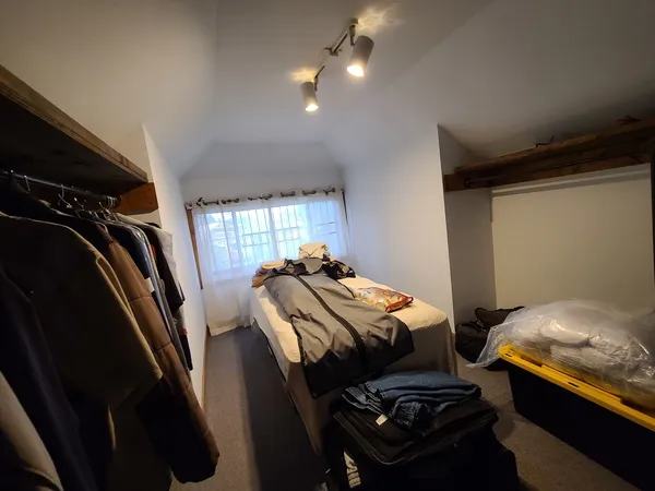 a bedroom with bed and a window