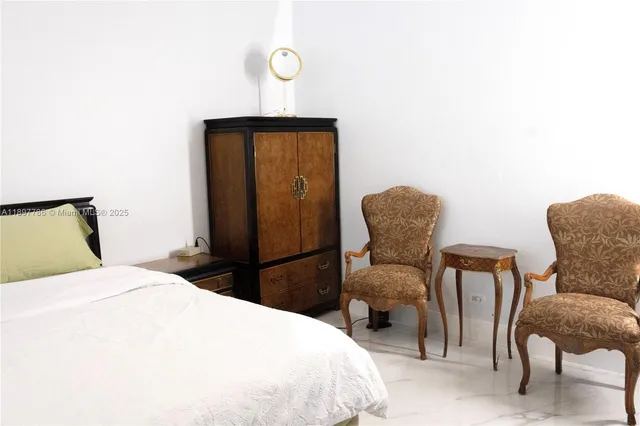 a bedroom with a bed and chair