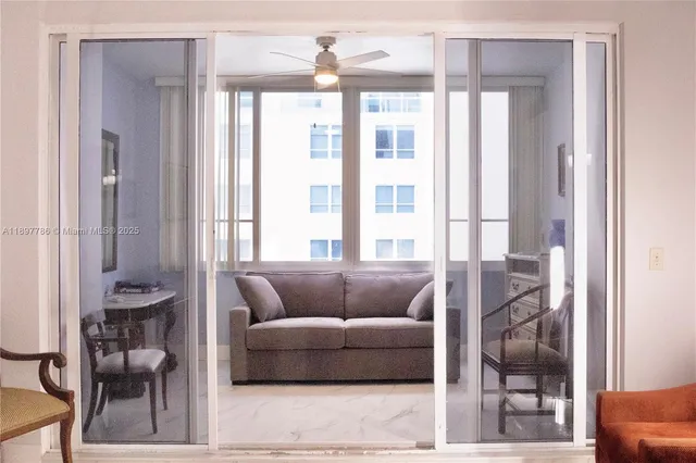 a living room with furniture and a large window