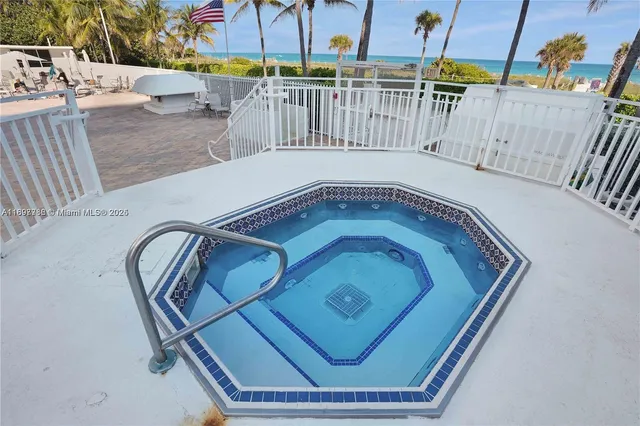 a view of a swimming pool with a yard