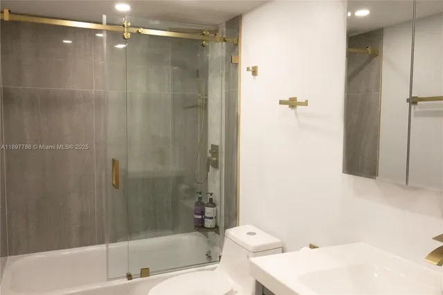 a bathroom with a bathtub and shower