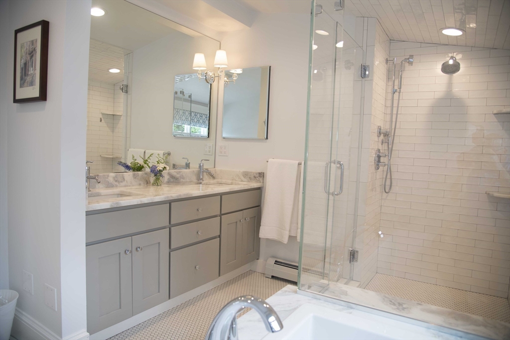3 Chester Road, Unit 3 Belmont, MA 02478 - Photo 19 of 40 a bathroom with a sink a vanity a mirror and shower