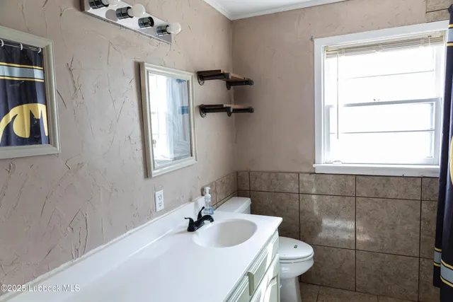 a bathroom with a sink toilet and mirror