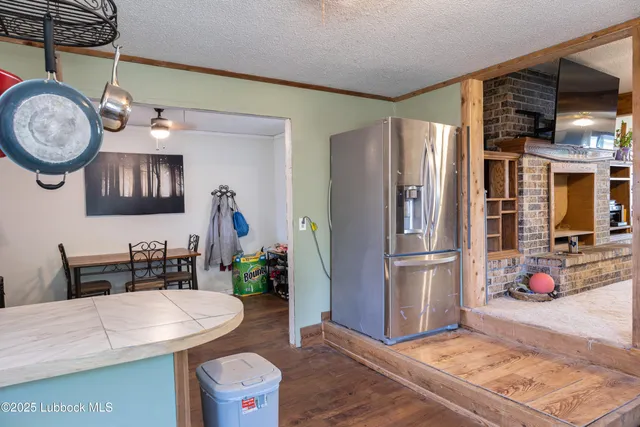 a kitchen with stainless steel appliances a stove a refrigerator a dining table and chairs