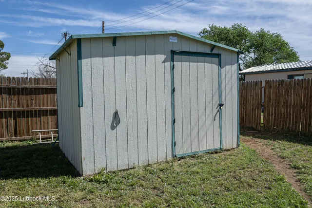 a view of wooden house with a yard