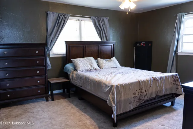 a large bed sitting in a bedroom next to a window