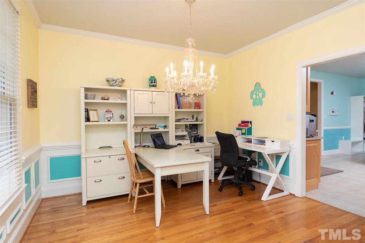 5912 Dean Avenue Raleigh, NC 27616 - Photo 3 of 24 a view of a workspace with furniture and wooden floor