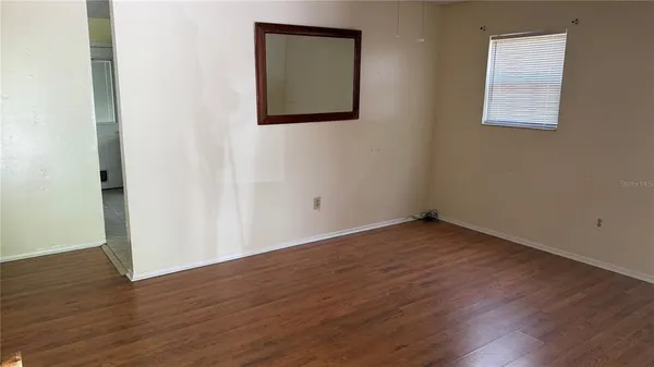 a utility room with mirror and window
