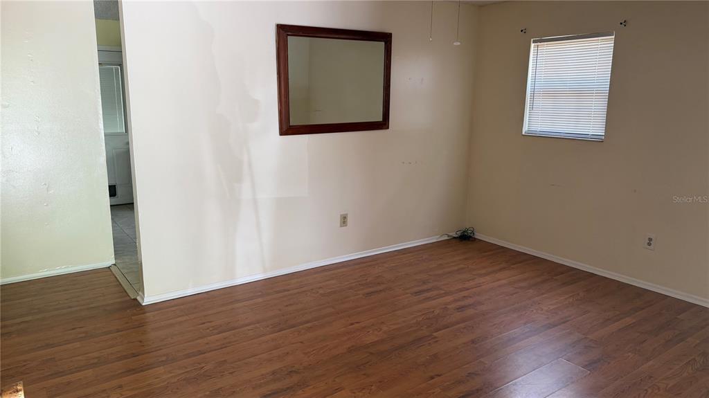 107 Eliam Road Melrose, FL 32666 - Photo 13 of 62 an empty room with wooden floor and windows