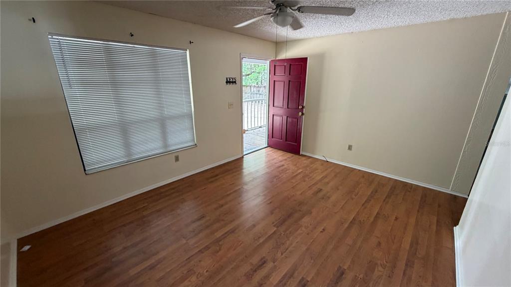 107 Eliam Road Melrose, FL 32666 - Photo 14 of 62 an empty room with wooden floor and entryway