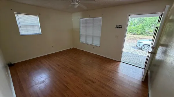 a view of a kitchen with a refrigerator cabinets and a ceiling fan