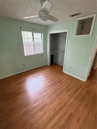 a room with a window and a ceiling fan