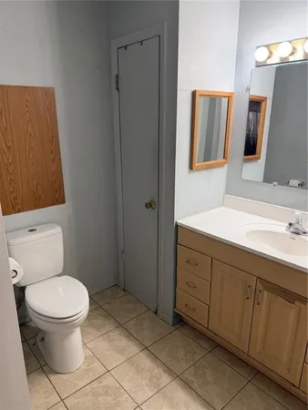 a bathroom with a double vanity sink a mirror and a bathtub