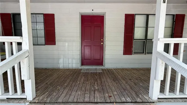 a view of a house with a yard and sitting area