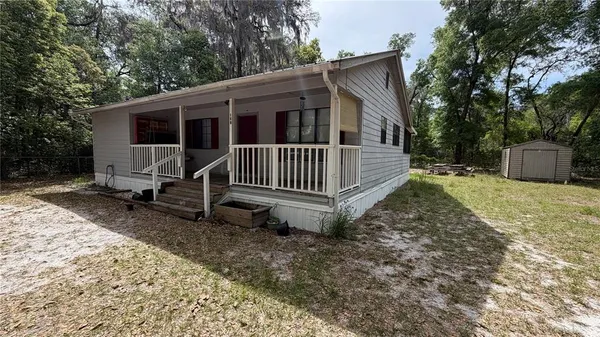 a view of a house with backyard and deck