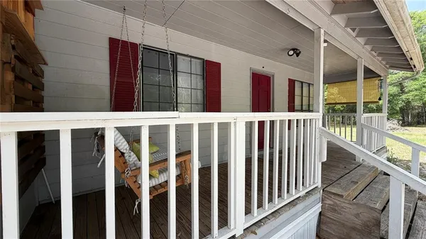 a view of front door and porch with wooden floor