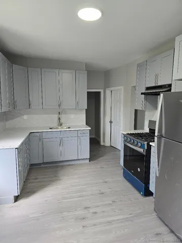 a kitchen with a sink cabinets and stainless steel appliances