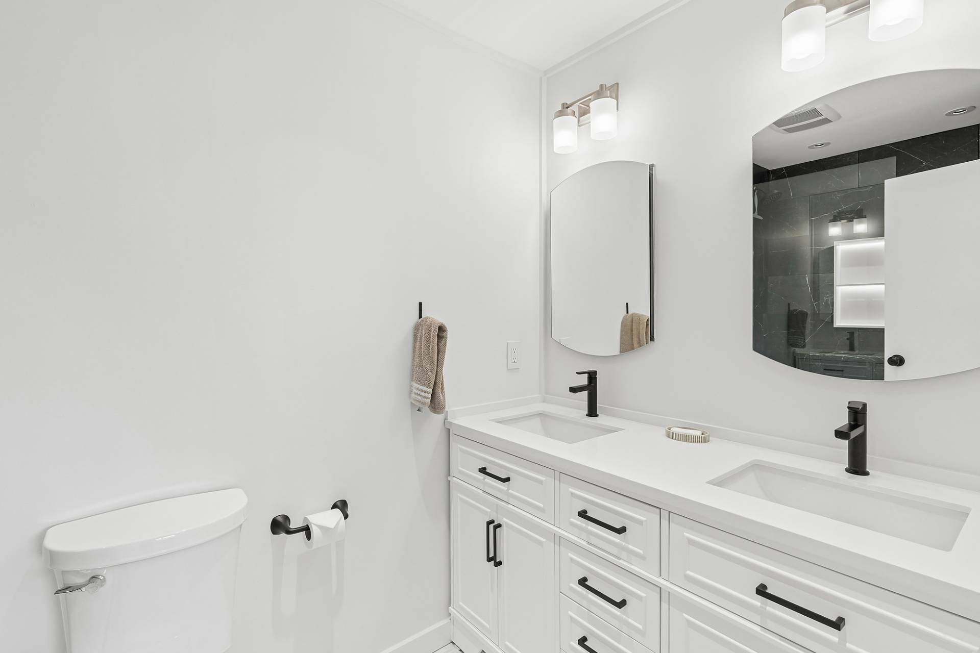 3004 Mitchell Road Westhampton Beach, NY 11978 - Photo 9 of 24 a bathroom with a double vanity sink and a mirror