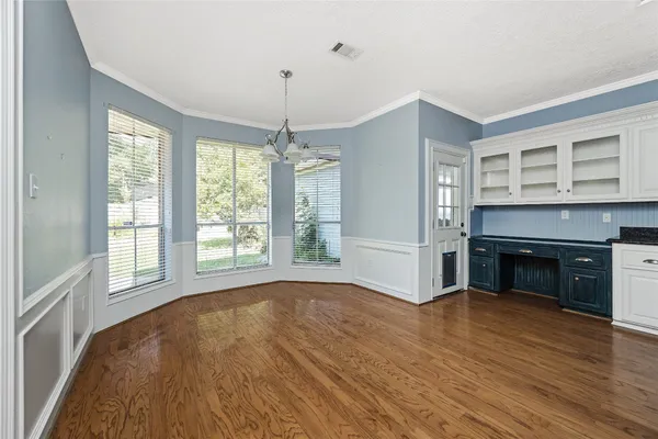 a view of empty room with wooden floor and fireplace