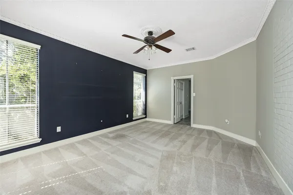 a view of a livingroom with a ceiling fan and window