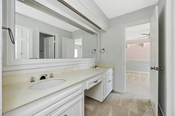 a bathroom with a granite countertop sink a mirror bathtub and shower