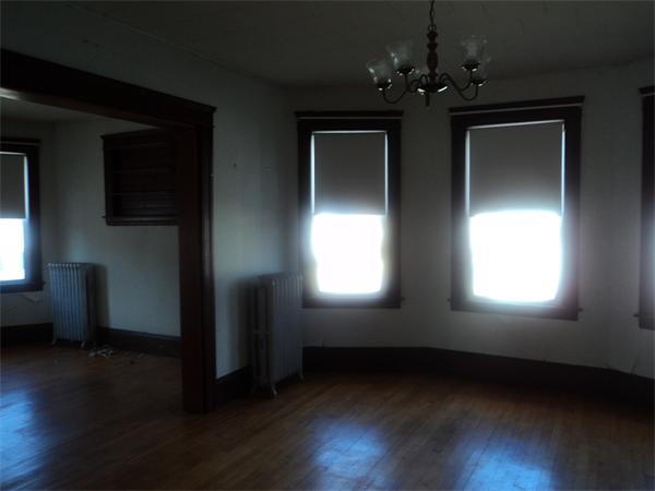 59 King Philip Road Worcester, MA 01606 - Photo 13 of 20 a view of an empty room with wooden floor and a window