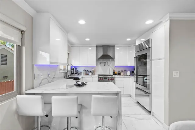 a kitchen with a refrigerator and a stove top oven