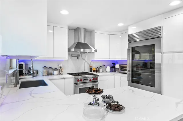 a kitchen with a stove a sink and a refrigerator