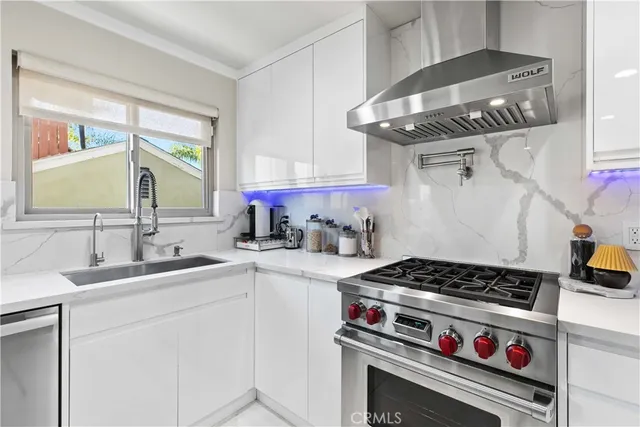 a kitchen with stainless steel appliances a stove and cabinets