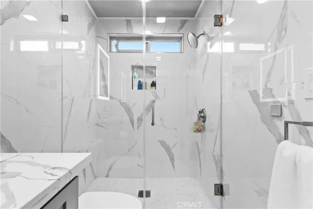 a bathroom with a double vanity sink mirror and toilet