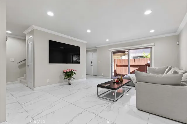 a living room with furniture and flowers