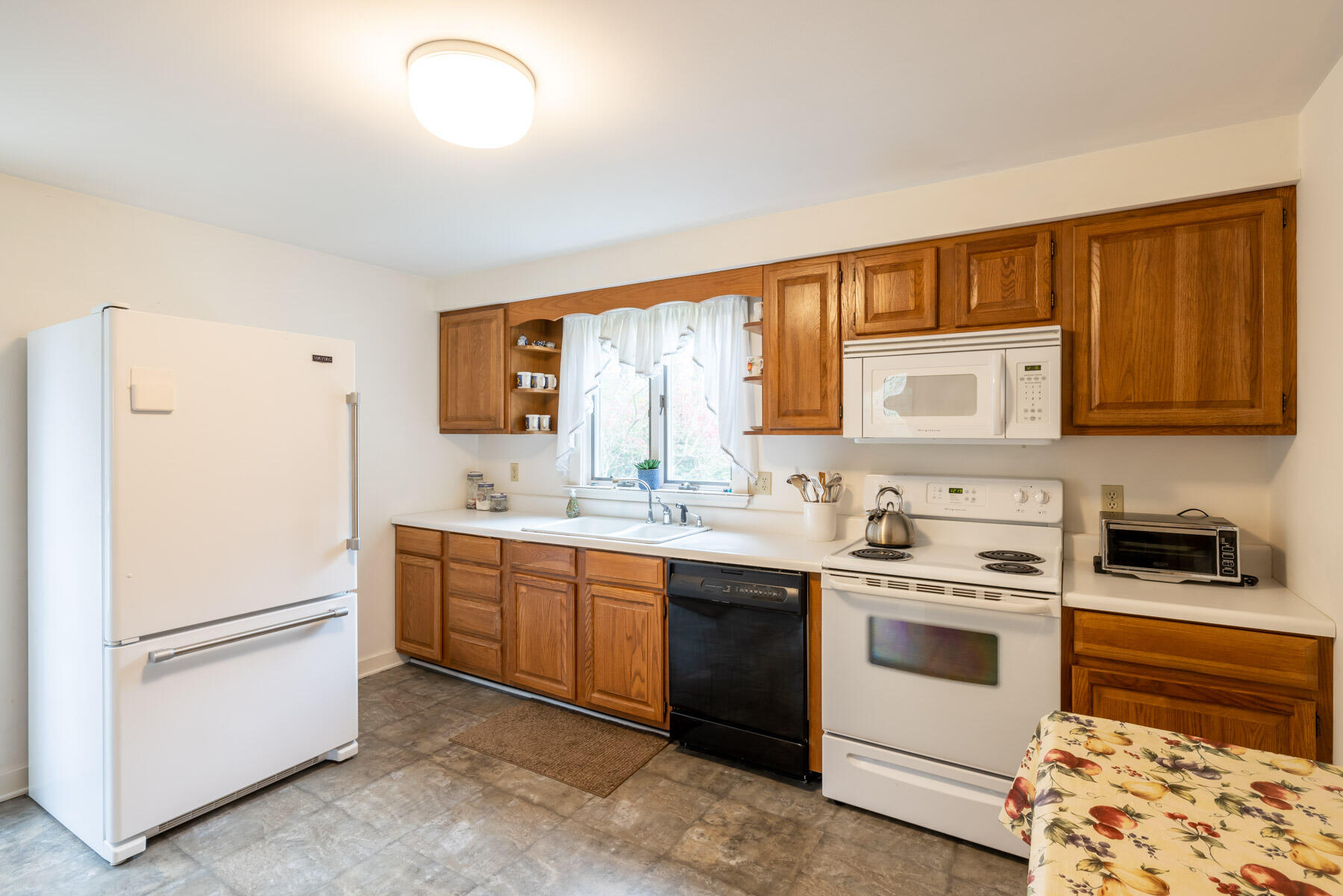 68 Marthas Road Edgartown, MA 02539 - Photo 3 of 20 a kitchen with a white stove top oven and sink