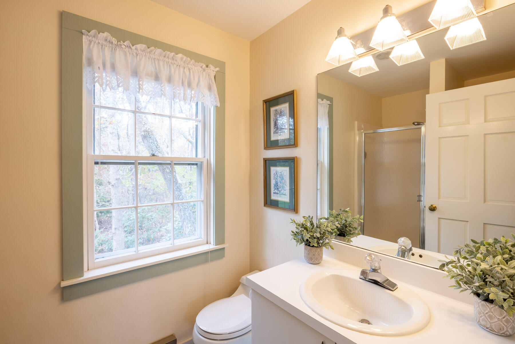 68 Marthas Road Edgartown, MA 02539 - Photo 7 of 20 a bathroom with a sink a toilet and a mirror