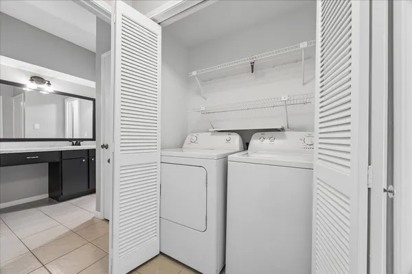 a bathroom with a granite countertop sink mirror and a bathtub
