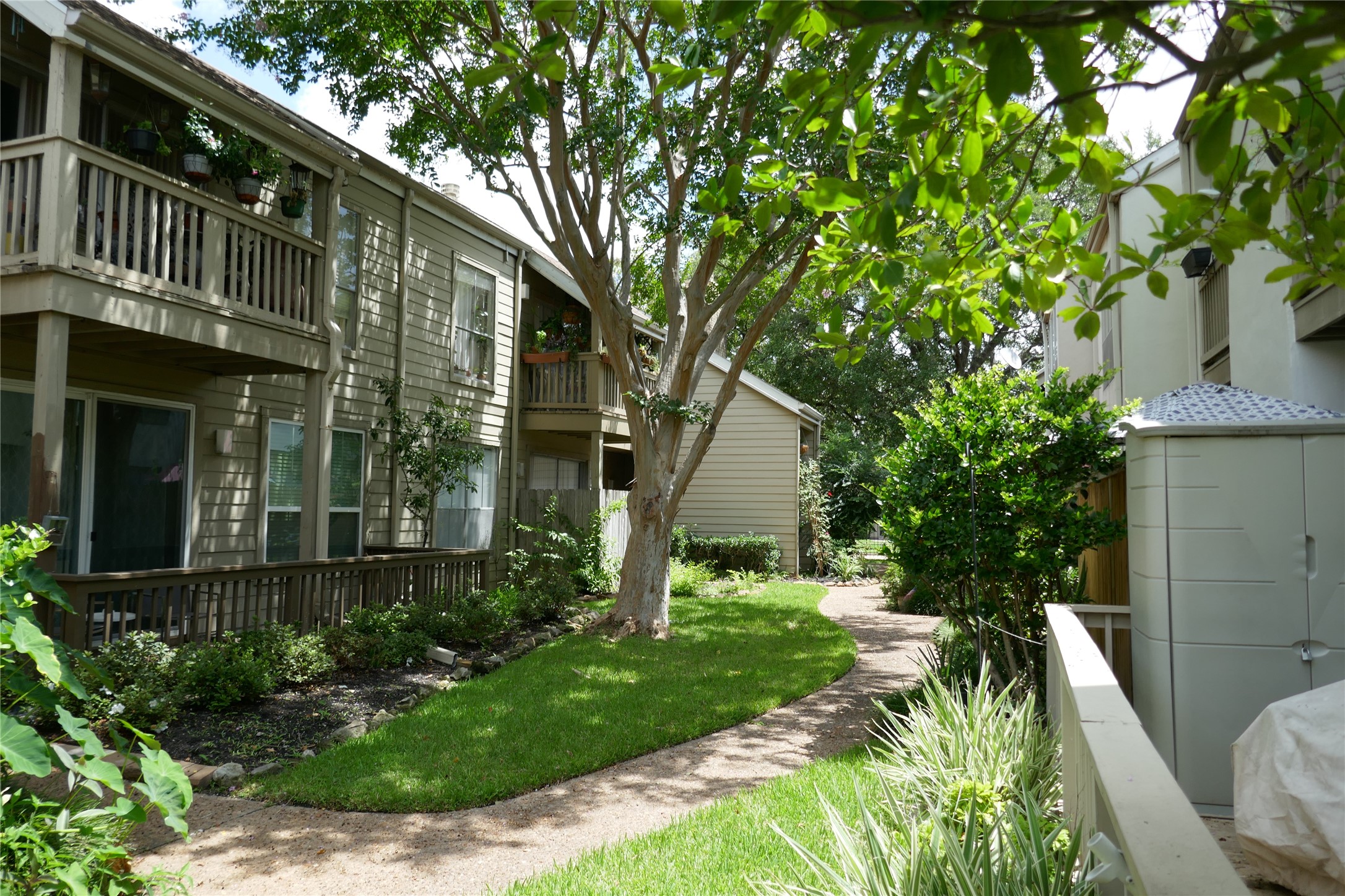 2100 Tanglewilde Street, Unit 124 Houston, TX 77063 - Photo 12 of 20 a front view of a house with garden