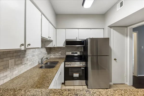 a view of a livingroom with wooden floor and a fireplace
