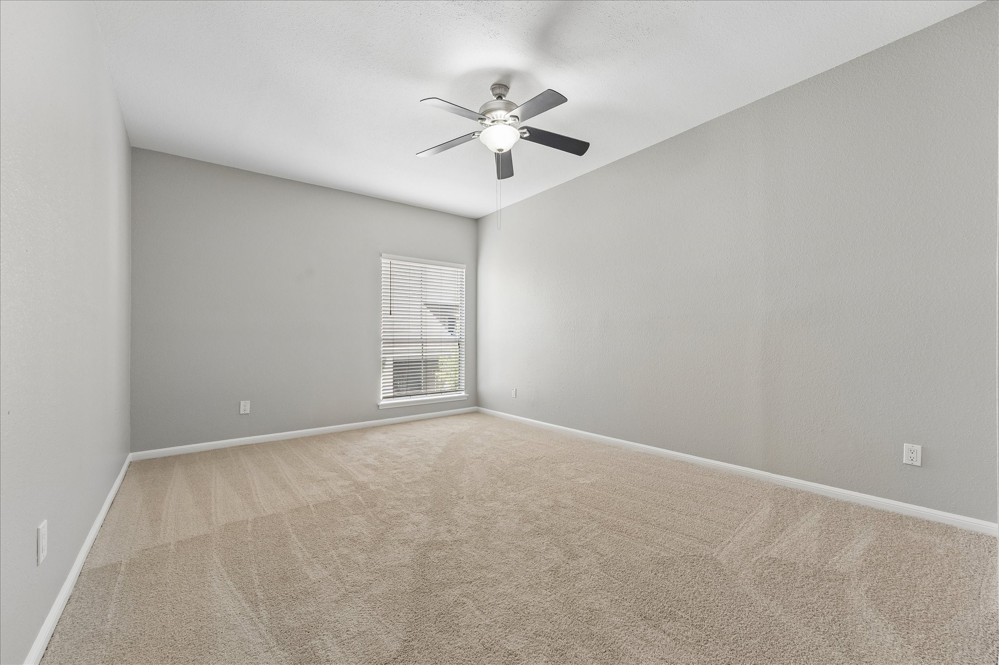 2100 Tanglewilde Street, Unit 124 Houston, TX 77063 - Photo 5 of 20 an empty room with a ceiling fan and window