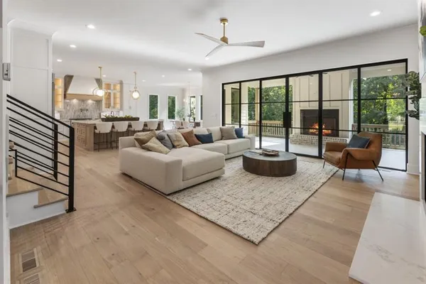 a living room with furniture and large windows