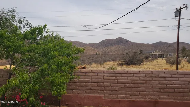 a view of a house with a yard and mountain view