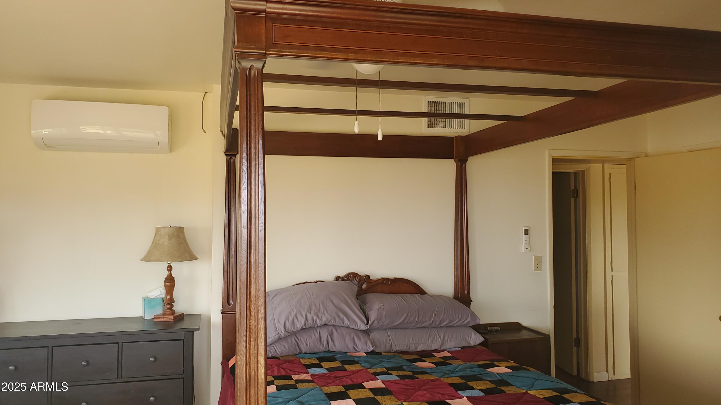 89 Pima Drive Bisbee, AZ 85603 - Photo 18 of 42 a bedroom with a bed and ceiling fan