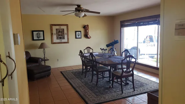 a dining room with furniture and window