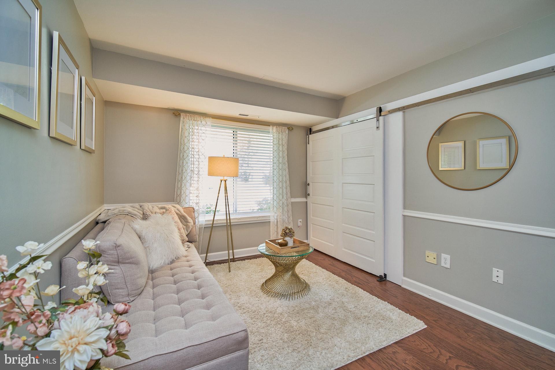 1813 Ivy Oak Square Reston, VA 20190 - Photo 12 of 28 Sitting area - laundry behind barn door